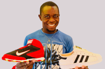 A man holds athletic shoes